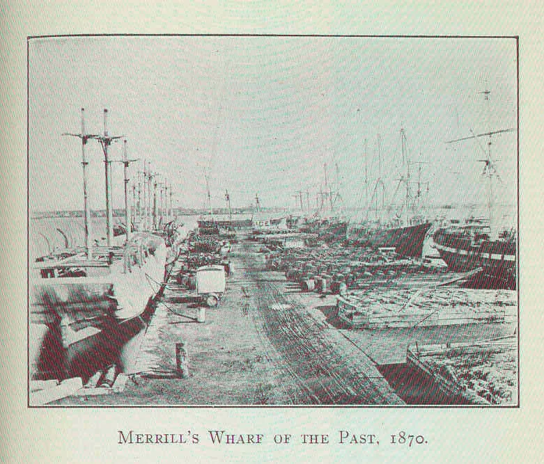 Una fotografía antigua: un muelle de New Bedford lleno de barriles y, detrás, los mástiles de los balleneros.